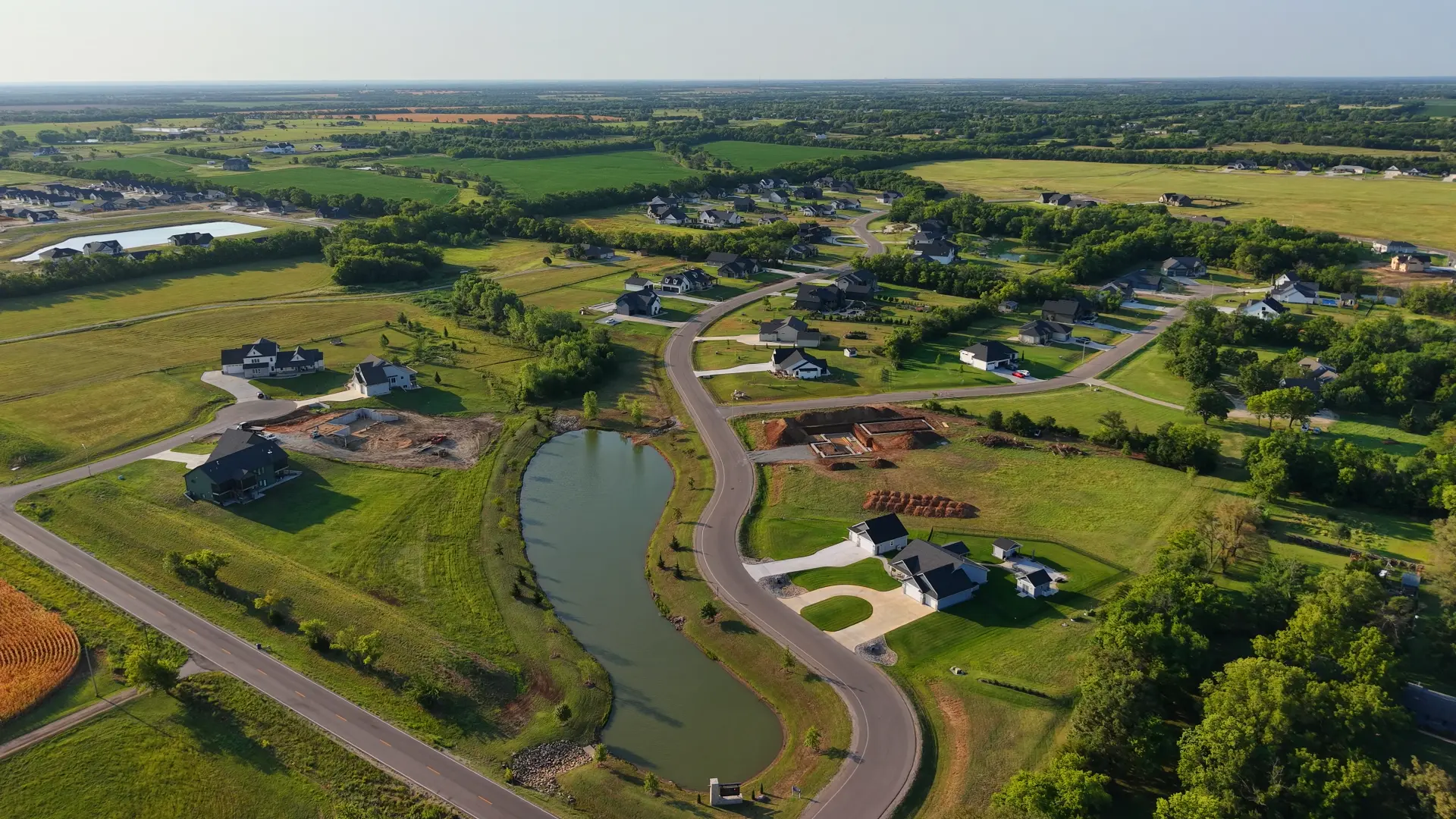 Aerial view of Cedar Ranch Estates with the pond and winding street